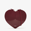 ALAÏA Le Coeur patent leather cross-body bag burgundy